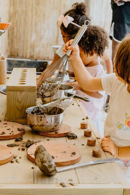 Pre-Primary children playing in the mud kitchen